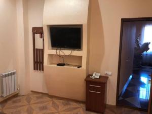 a room with a flat screen tv on a wall at Hrashq Hotel in Yerevan