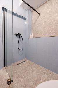 a bathroom with a shower with blue tiles at Casa Romana in Bucharest