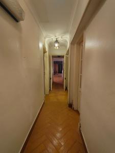 a hallway of an empty room with a wooden floor at شقه مفروشه مميزه جدا لعائله بالدقي in Cairo