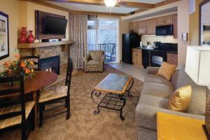a living room with a couch and a table at Holiday Inn Club Vacations Smoky Mountain Resort in Gatlinburg