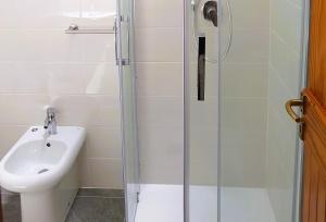 a bathroom with a sink and a glass shower at Rosa dei venti in Stintino