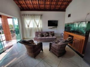 ein Wohnzimmer mit einem Aquarium und 2 Stühlen in der Unterkunft Casa de Hóspede Canto do Canto in Itapetininga