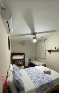 a bedroom with a bed and a ceiling fan at Recanto do Abraao Ilha Grande in Angra dos Reis