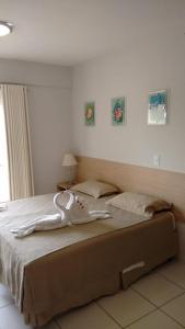 a large bed with a white object on it at Flat - Condomínio Golden Dolphin Express in Caldas Novas
