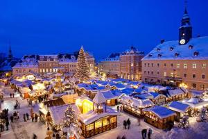 Un mercado de Navidad en una ciudad por la noche en A la porte des vosges en Raon-lʼÉtape