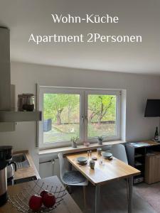 a kitchen with a wooden table and a window at Ferienwohnung Zenzen in Cochem