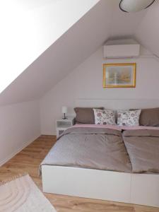 a bedroom with a large bed in a attic at Lea in Samobor