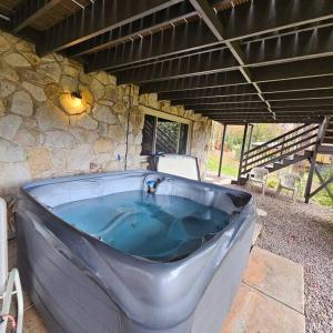 a large bath tub in a stone building at Alpine Retreat @ Seven Springs! in Champion