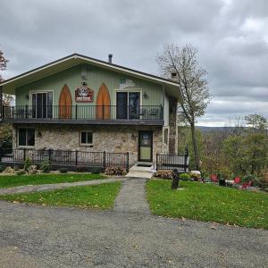 a large house with a balcony on top of it at Alpine Retreat @ Seven Springs! in Champion