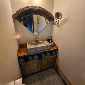 a bathroom with a sink and a mirror at Alpine Retreat @ Seven Springs! in Champion