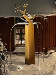 a sculpture in the snow in front of a building at Lilla Hotellet in Tranemo