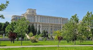 a large building with a park in front of it at Beautiful 2BedFlatCismigiu in Bucharest