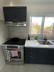 a kitchen with a stove and a sink at Charming One Bedroom Near Bramalea City Centre in Brampton