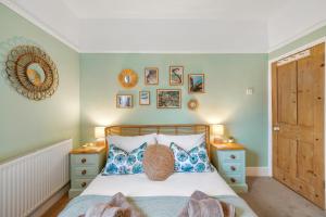 1 dormitorio con 1 cama y algunas fotos en la pared en 3 - Bed Spacious Luxury Townhouse, Great for Contractors & Groups l Sleeps 6 with Free Parking - Blue Puffin Stays, en Portsmouth