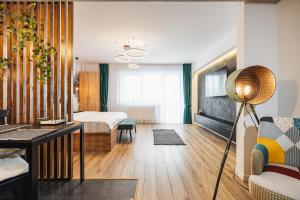 a bedroom with a bed and a living room at A Guesthouse Sibiu in Sibiu +21 photos