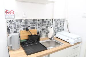 a small kitchen with a sink and a sink at Saska Kępa Luxe Apartment in Warsaw