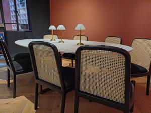 a table and chairs with lamps on top of it at Casa Altata Hotel Boutique in Mexico City