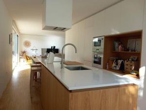 a kitchen with a sink and a counter top at Casa moderna julio y agosto in Ferrol