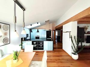 a kitchen with white cabinets and a wooden floor at Apartment Baumblick mit Whirlpool in Medraz