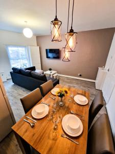 a wooden table with chairs and a dining room at Cosy modern 1 Bedroom apartment! in Liverpool