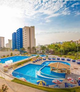 a group of swimming pools in a city at Flat - Condomínio Golden Dolphin Express in Caldas Novas