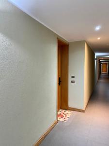 an empty hallway with a hallway leading to a door at Hermoso y tranquilo departamento frente al mar. in Concón