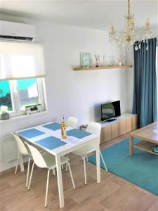 comedor con mesa blanca y sillas en Modrý apartmán 1, en Znojmo