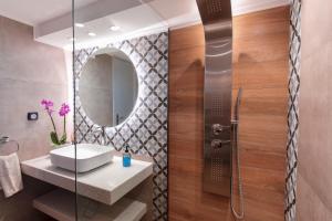 a bathroom with a sink and a mirror at Elysian Rose Residence in Rethymno