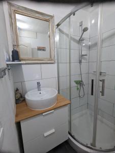a bathroom with a sink and a shower at Appartment mit Charme am Strand in La Pared