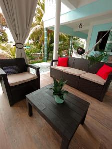 a living room with a couch and a coffee table at Pousada Carvalhos - Camaçari in Camaçari