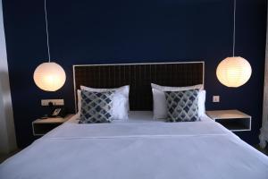 a bedroom with a large bed with two lamps at BeachMirissa Hotel in Mirissa