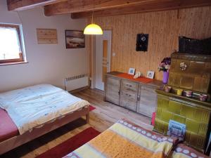 a bedroom with a bed and a dresser in it at Chata Safran in Donovaly