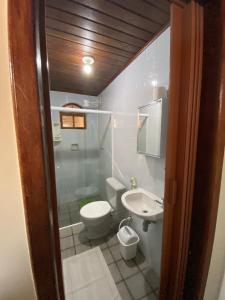 a bathroom with a toilet and a shower and a sink at Recanto da Bruna in Abraão