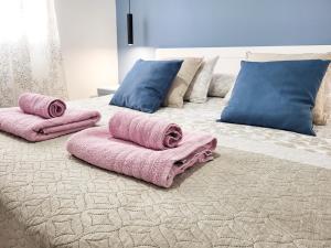 a bed with pink blankets and pillows on it at Optimist las americas in Playa de las Americas +17 photos