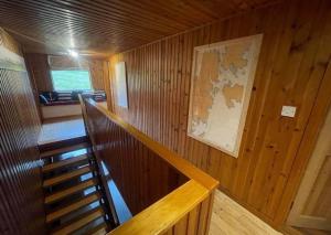 a wooden room with a staircase in a cabin at Sea View B & B in Ulsta