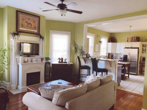a living room with a couch and a table and a kitchen at Kathy's Place - Pet Fee Additional Charge in Lexington