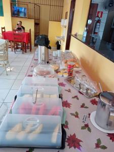 a table with several boxes of food on it at BELAS PRAIAS POUSADA in Alter do Chao