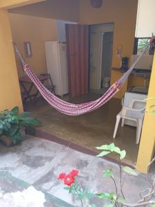 a hammock in the middle of a living room at Casa Repousar in Lençóis