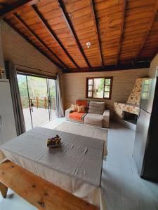 a living room with a table and a couch at Casa da Cachoeira Siriú-SC in Garopaba