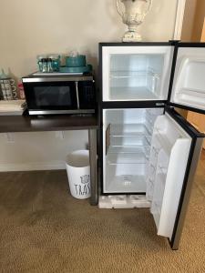 an open refrigerator with a microwave on a table at Susan’s Place in Deltona