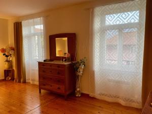 a bathroom with a dresser and a mirror and a window at 1912 - Wooden Room - old town in Locarno