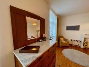 a bathroom with a counter with a mirror and a sink at 1912 - Wooden Room - old town in Locarno