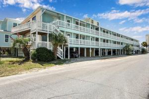 a large apartment building with a street in front of it at 2-BDRM Across From Beach 10 min Walk to Hangout! in Gulf Shores