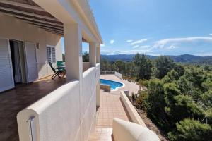 a balcony of a house with a swimming pool at beautiful views with pool in ibiza in Sant Miquel de Balansat