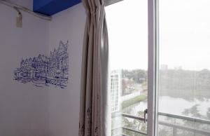 a room with a window with a drawing on the wall at 夕映安平 in Tainan