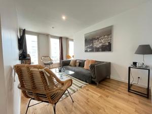 a living room with a couch and a chair at Appartement la défense Courbevoie in Courbevoie