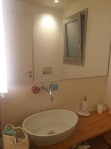 a bathroom with a white sink and a mirror at Διαμέρισμα 130 τμ in Athens