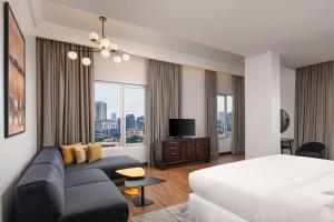 a hotel room with a bed and a couch at Four Points by Sheraton Lagos in Lagos
