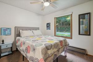 een slaapkamer met een bed en een plafondventilator bij Kickapoo Creekside Escape in Danville