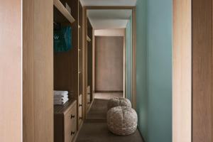 a room with a hallway with a chair and a mirror at W Algarve in Albufeira